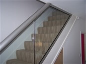 Glass Balustrades on stairs runs and staircases. Balcony systems introduces a 72mm X 72mm Newel Post that allows glass balustrades and railings to be used on stair runs easily.