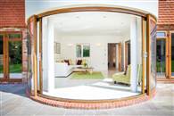 An article with images showing the transformation curved sliding doors can make to a home with a view, particularly when they lead out to a curved balcony!