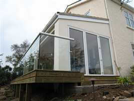 White handrail on semi frameless structural glass balustrade