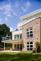 Side view of a school with white balustrading and blue skies