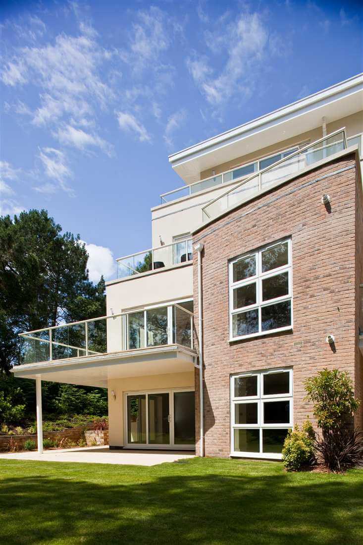 Side view of a school with white balustrading and blue skies
