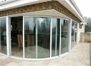 A three pane Curved Patio Door, Tinted Glass Balustrades on a large terrace and a Juliet balcony in this luxury five-bedroomed house.