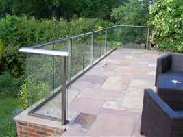 Royal Chrome balustrade on a tiled patio in a pretty garden