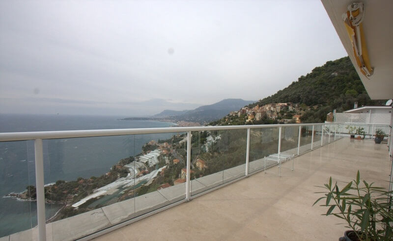 White balustrade with beautiful views down the mountain to the sea