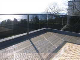 Bronze balcony with grey tint glass by the sea