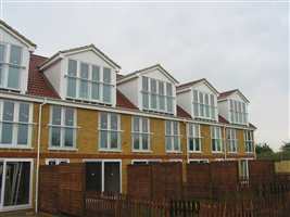 Matching White Juliet balconies at the back of the residences