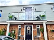 Completely redesigning the front of their detached home has given a Swindon family-of-four more space and light, thanks to this beautiful glass balustrade and adjacent Juliet glass balconies supplied by Balconette.