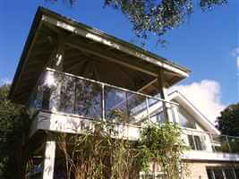 Side view of house with balcony and bamboo trees