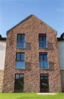 Juliet balconies on brick wall with Royal Chrome handrail and blue sky