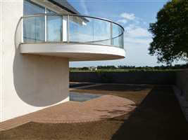 Curved balcony with Royal Chrome handrails overlooking the garden