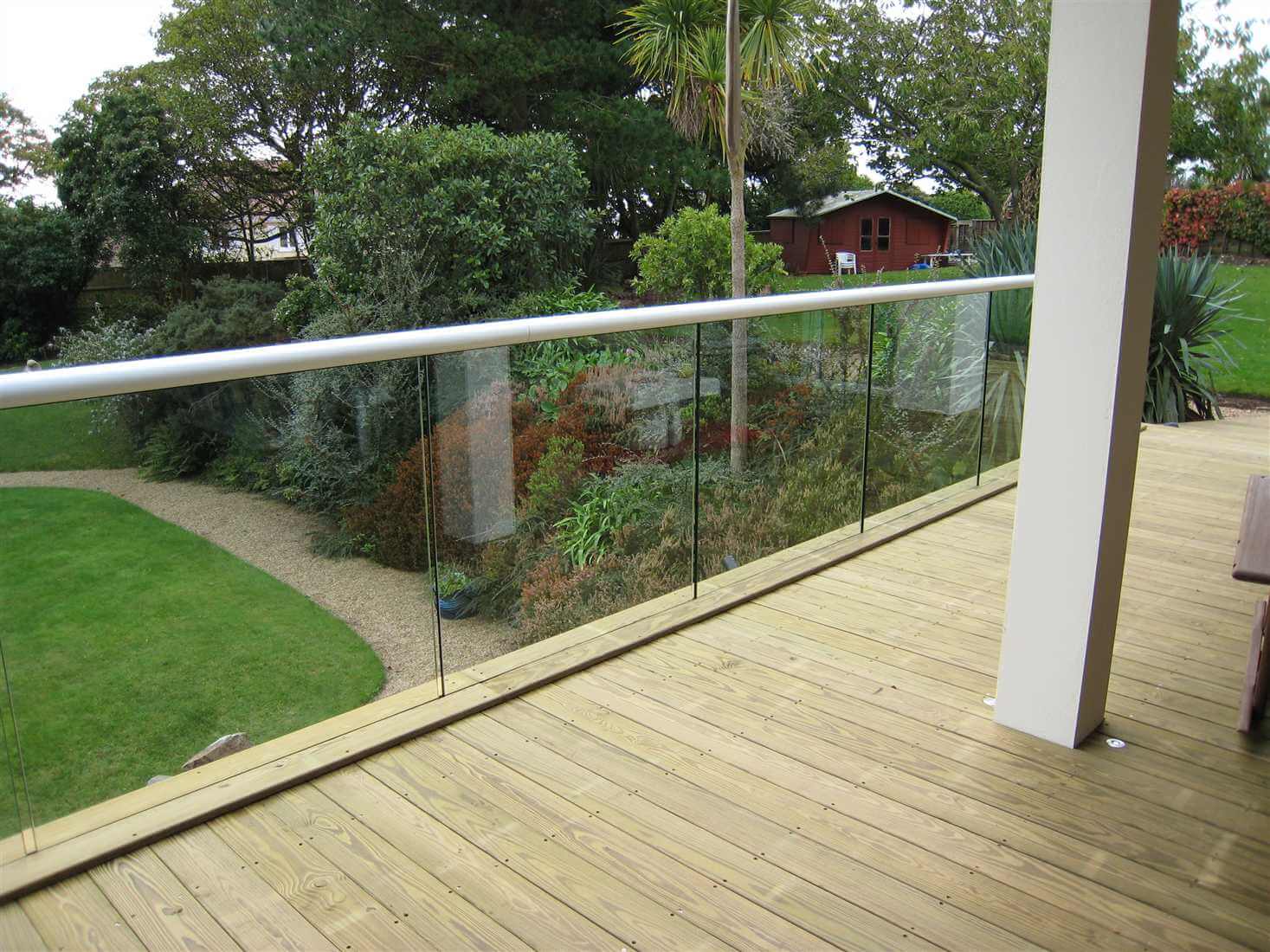 structural glass balcony with white handrail