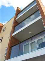 Looking up at a block of flats with Royal Chrome balconies