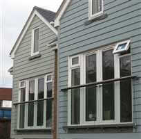 Juliet balconies with Royal Chrome handrails on a blue property