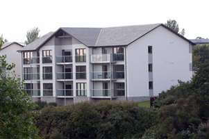 An overall image of the recidency surrounded by greenery