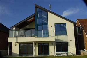 Intricately designed house with stunning glass balcony and Royal Chrome handrails