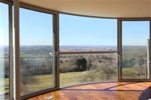 curved sliding doors  with curved juliet balcony in south england