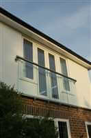 Royal Chrome Juliet balcony looking out onto garden with blue sky