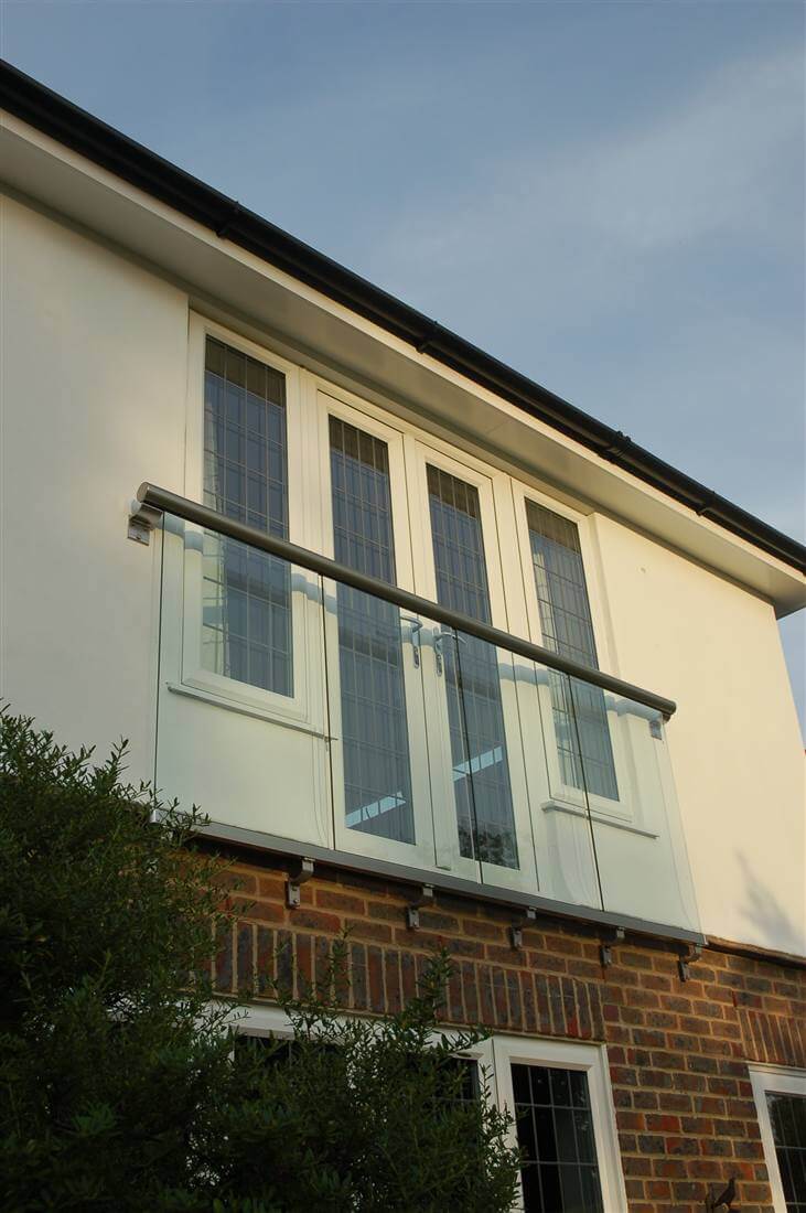 Royal Chrome Juliet balcony looking out onto garden with blue sky