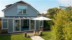 A Review of a Juliet Balcony in Sandown, Isle of Wight. 70mm handrail Juliette Balcony, opening width 2450mm, Silver Anodized colour finish, 10mm clear toughened glass.