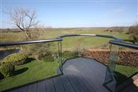 Replacing an old wooden balcony with a combination of Balconette glass balustrades, overlooking unspoiled West Sussex countryside