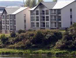 River shot of the recidency with silver handrail balustrading