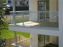 White balconies on a white house in the sunshine