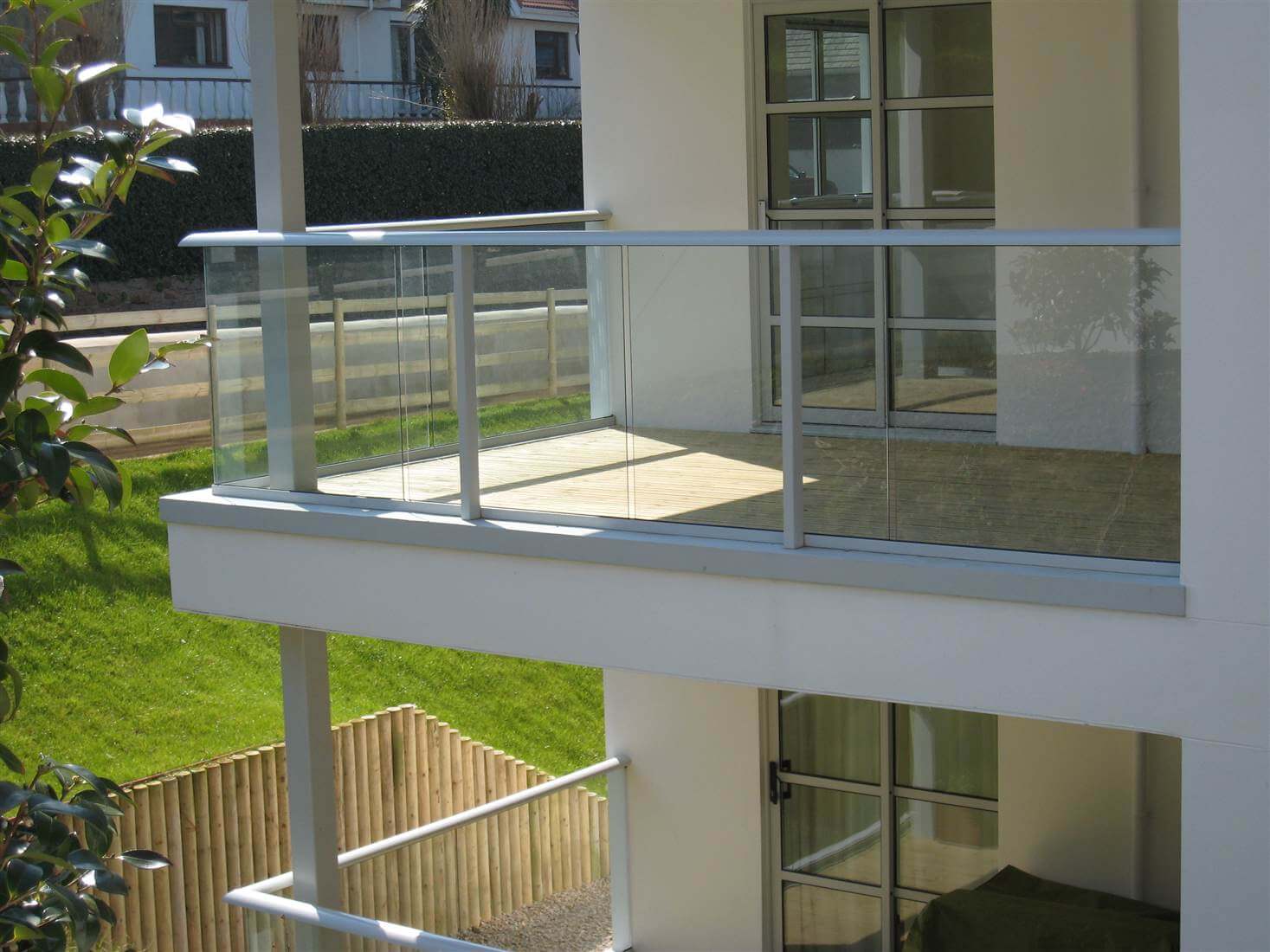 White balconies on a white house in the sunshine