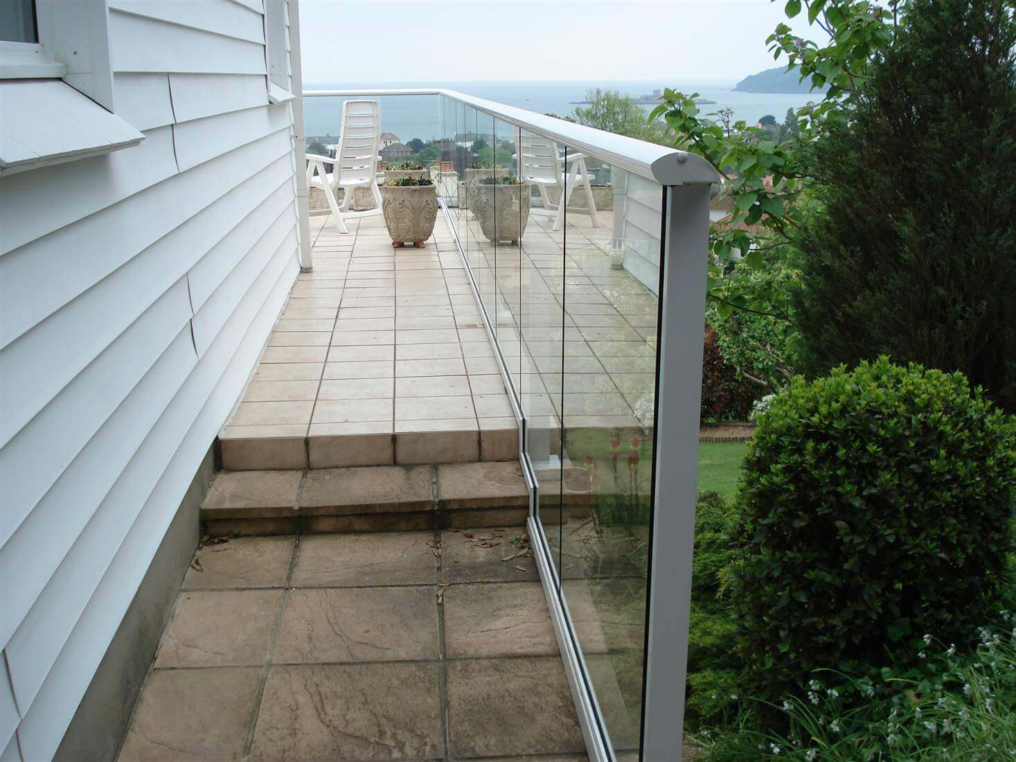 Side on view of a white aerofoil balustrade on a white house