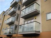 Contemporary Glass Juliette Balconies and Glass Balustrades with Aluminium handrails match modern new build of apartments in Hemel Hempstead.