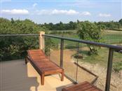 Glass Balcony Review. Balcony 2 system glass balustrade in Dorking, Surrey. Colour finish: Royal Chrome Anodized. Glass: 10mm Clear Tough with BalcoNano® Self-Cleaning Coating both Sides