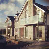 Matching Royal Chrome balconies on the front of a large house