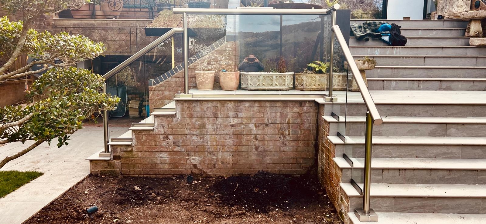 Exterior staircase with glass balustrade and aluminium handrails