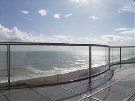 curved glass shiney balcony in the sunset