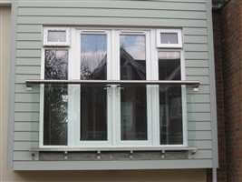 Royal Chrome Juliet balcony on blue house