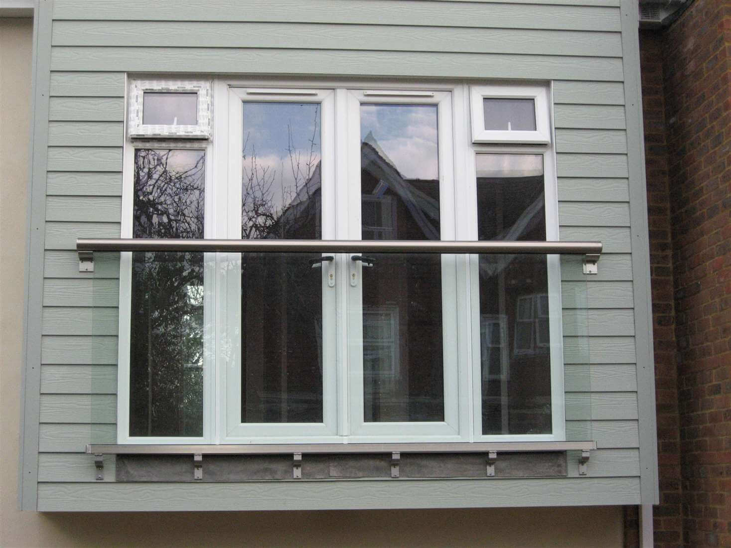 Royal Chrome Juliet balcony on blue house