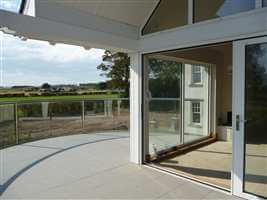 Curved Royal Chrome balcony surrounded by land