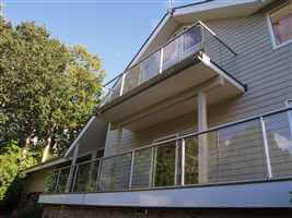 Double silver balconies on the side of a pretty house