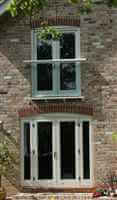 Small Silver Juliet balcony on side wall of house in the sun