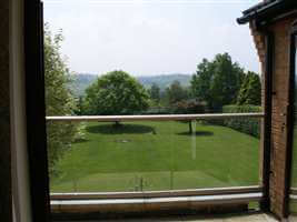 View from a clear glass, white handrailed balcony