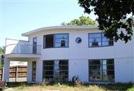 Contemporary Art Deco-influenced property on the South Coast enhanced by innovative curved glass solution from Balcony Systems