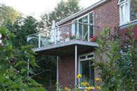  A simple house is transformed by a Glass Balustrade extension and at over 5 metres wide it is big enough to host a dinner party on! 