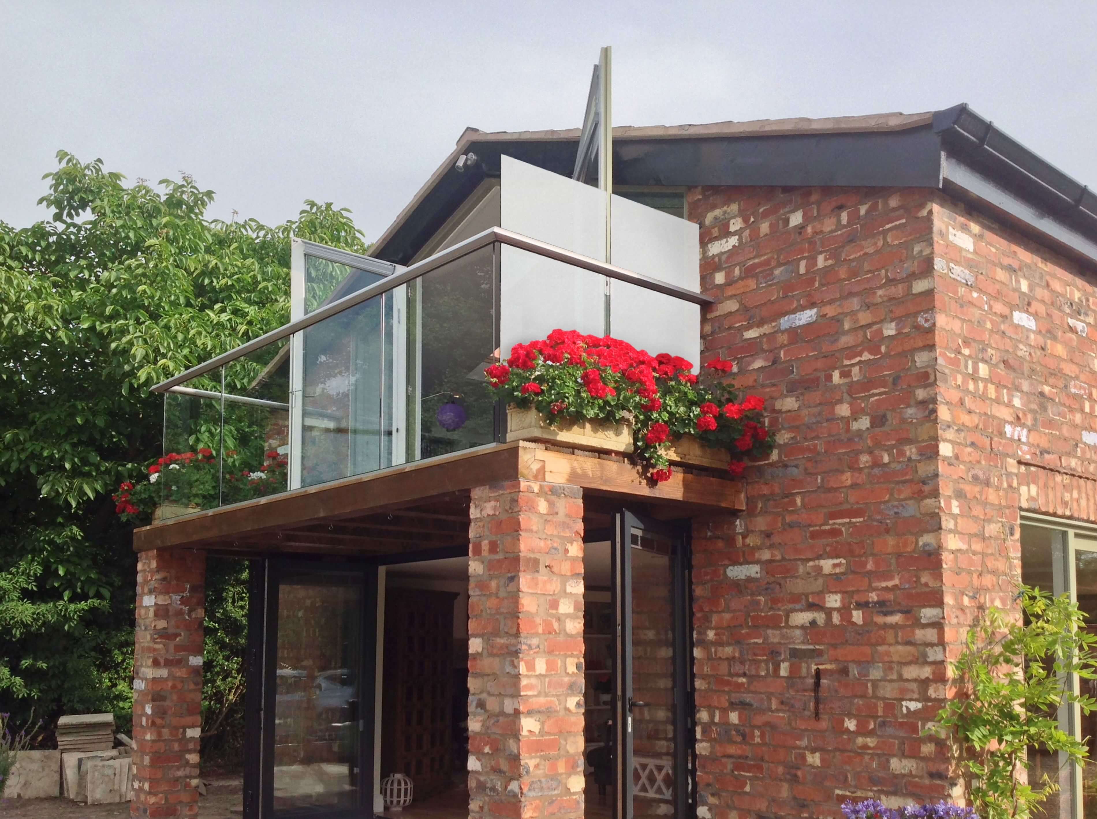 Satin glass privacy screen providing screening to an outdoor space