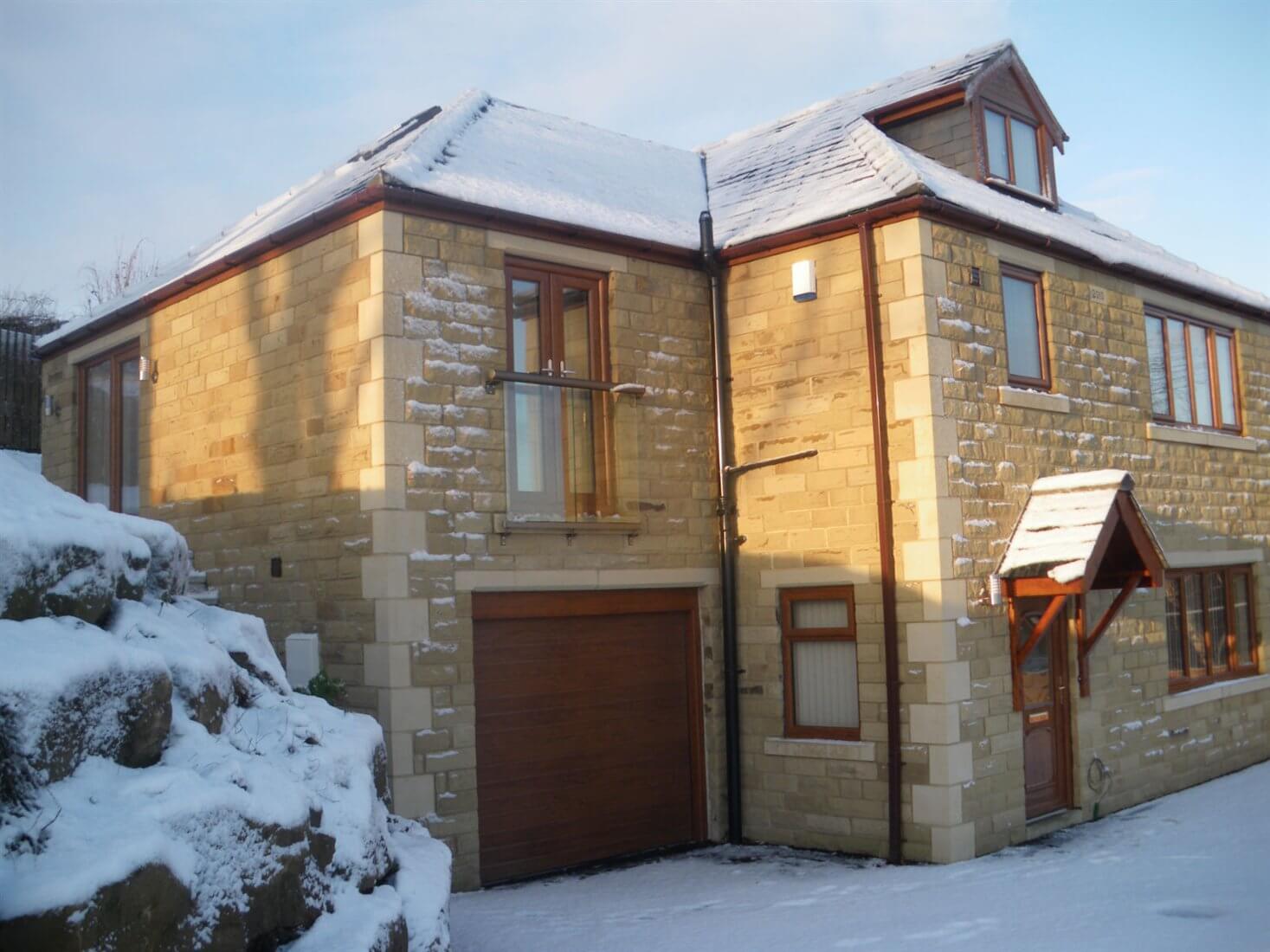 Bronze Juliet balcony on a snowy house