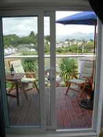 Looking out on to a balcony with silver handrails overlooking the harbour