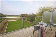 Two large glass balustrades supplied by Balconette span the front and rear elevations of this extensively re-modelled property in a sought-after Norfolk coastal village.