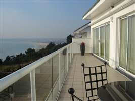 Beautiful view from a balcony with white handrail in the mountains