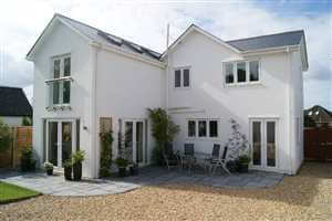 Small Juliet balcony with a Royal Chrome handrail on a beautiful white house