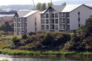 Large building on the river with silver balustrades