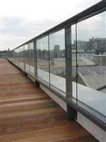 Long straight glass balcony with Royal Chome handrails and city views