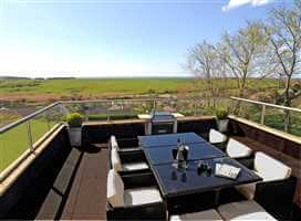 table and chairs set up on a Royal Chrome balustrade balcony with stunning countryside views